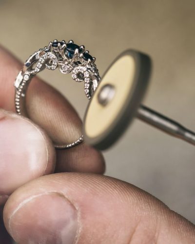 Jeweler polishes a gold ring in the workshop. Close-up workflow